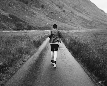 Grayscale Photo Of Person Running On Path