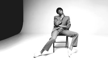 Grayscale Photo of Person Sitting on Chair