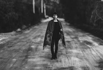 Grayscale Photo of Person Standing on Road