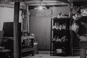 Grayscale Photo of Racks and Bottles