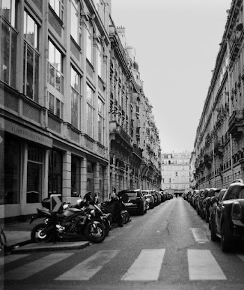 Grayscale Photo of Road Between Buildings