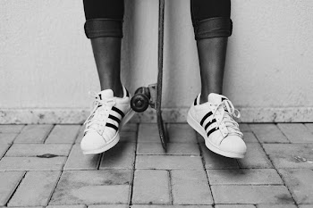 Grayscale Photo Of Shoes And Skateboard