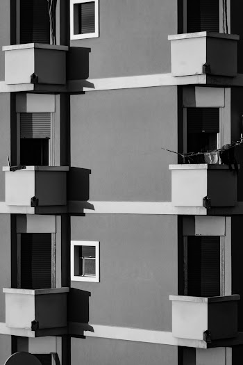 Grayscale Photo of Side of a Building with Balconies