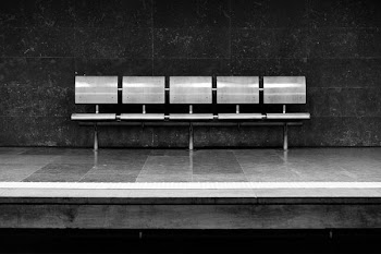 grayscale photo of silver 5-seat gang chair