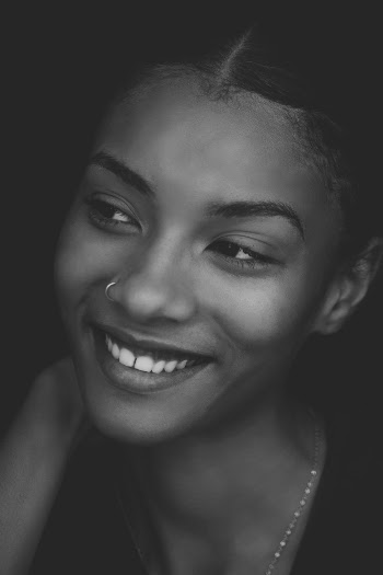 Grayscale Photo of Smiling Woman