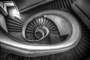 Grayscale Photo of Spiral Stairs