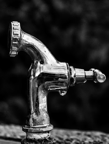Grayscale Photo Of Stainless Steel Faucet