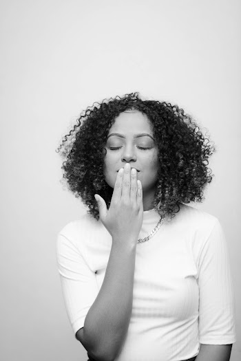 Grayscale Photo of Standing Woman With Her Eyes Closed Covering Her Mouth With Her Hand