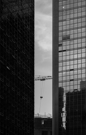 Grayscale Photo of two high rise buildings