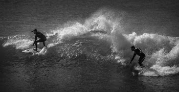 Grayscale Photo of Two Men Surfing
