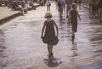 Grayscale Photo of Two Woman Walks on Bricks Pavement Front of People at Daytime