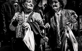 grayscale photo of two women holding bags