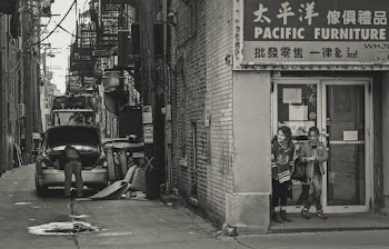 Grayscale Photo of Two Women Standing Beside Pacific Furniture Shop