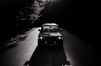 grayscale photo of vehicle on road