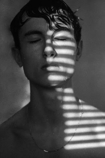 grayscale photo of wet man