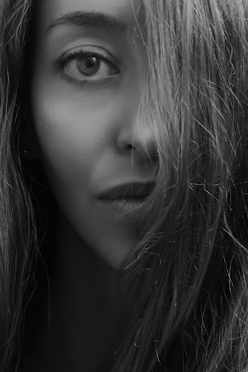 Grayscale Photo of Woman Covering Half Face With Hairs