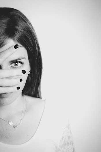 Grayscale Photo of Woman Covering Her Face