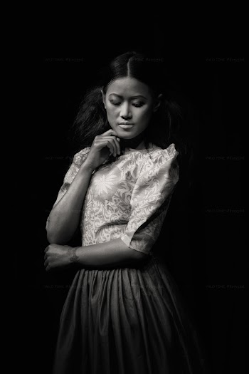 Grayscale Photo of Woman Floral Elbow-sleeved Dress Posing While Looking Down