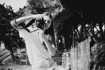 Grayscale Photo of Woman Holding Camera