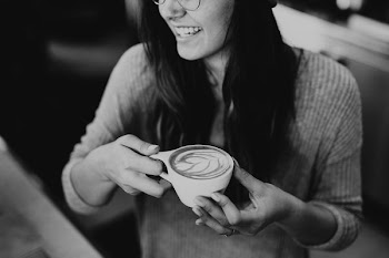grayscale photo of woman holding coffee