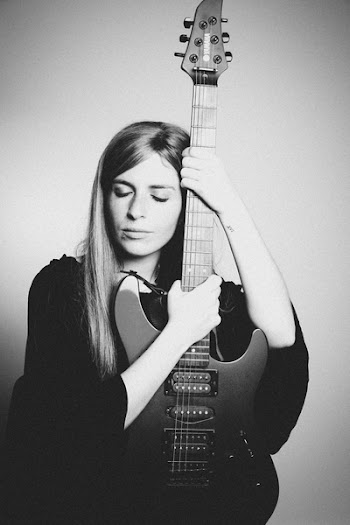 Grayscale Photo of Woman Holding Electric Guitar