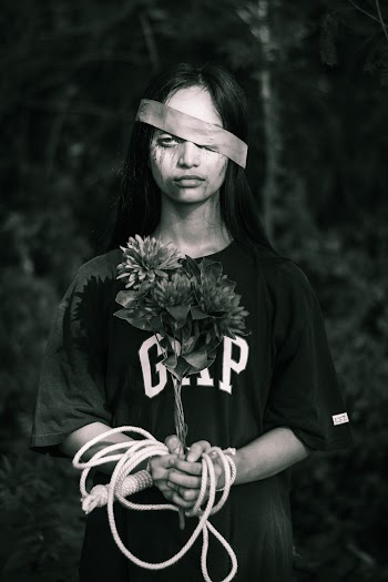 Grayscale Photo of Woman Holding Flower of Bouquet