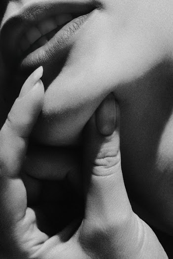 Grayscale Photo of Woman Holding Lips