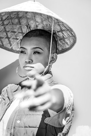 Grayscale Photo of Woman in Bamboo Hat Pointing Finger While Looking away
