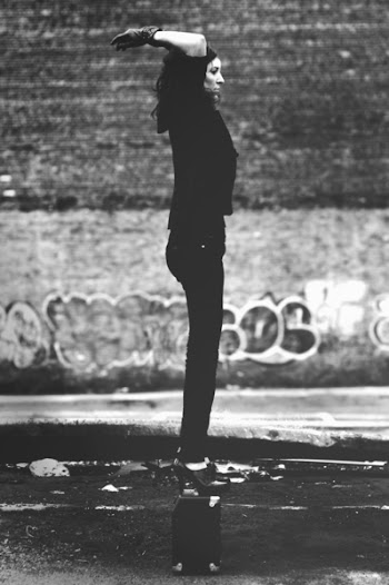 Grayscale Photo of Woman in Black Short-sleeved Shirt and Black Pants