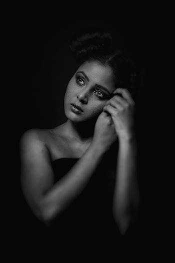 Grayscale Photo of Woman in Dark Room Posing