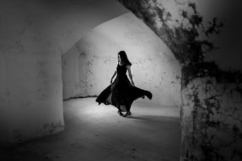 Grayscale Photo of Woman in Dress in Concrete Building