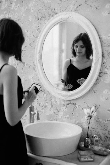 Grayscale Photo of Woman in Front of Mirror