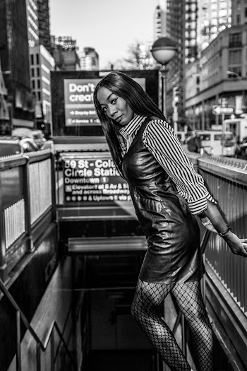 Grayscale Photo of Woman in Striped Long-sleeved Dress