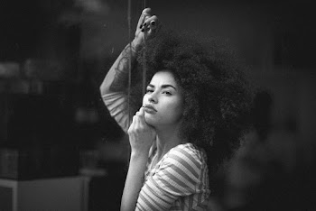 Grayscale Photo of Woman in Striped Long-sleeved Shirt
