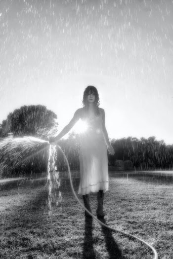 Grayscale Photo of Woman in White Dress Standing on Grass Field · Free Stock Photo