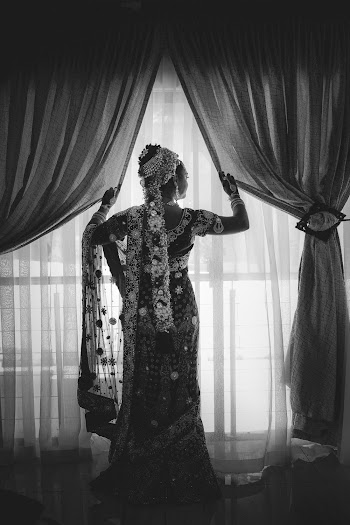 Grayscale Photo of Woman in White Sheer Dress Standing by the Window