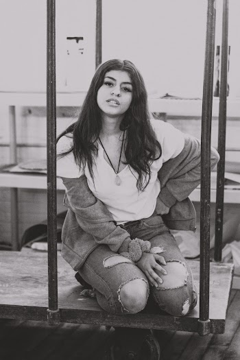 Grayscale Photo of Woman Kneeling on Hand Truck