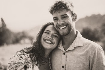 Grayscale Photo of Woman Leaning Head on Man's Right Shoulder