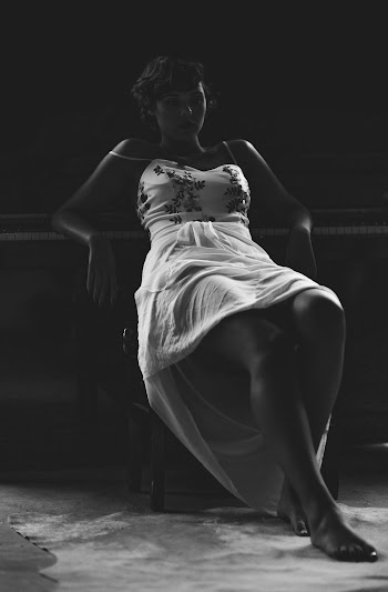 Grayscale Photo of Woman Sitting on Chair