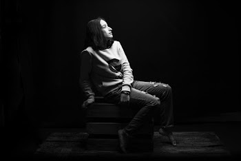 Grayscale Photo of Woman Sitting on Wooden Crate