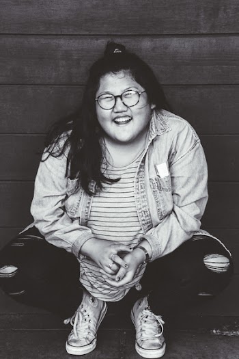 Grayscale Photo of Woman Squat Sitting