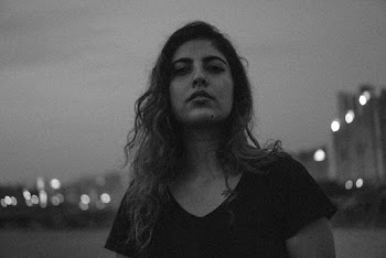 Grayscale Photo of Woman Standing on Field