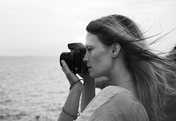 grayscale photo of woman taking photo using black DSLR camera