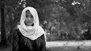 Grayscale Photo of Woman Wearing Abaya Headdress Near Tree