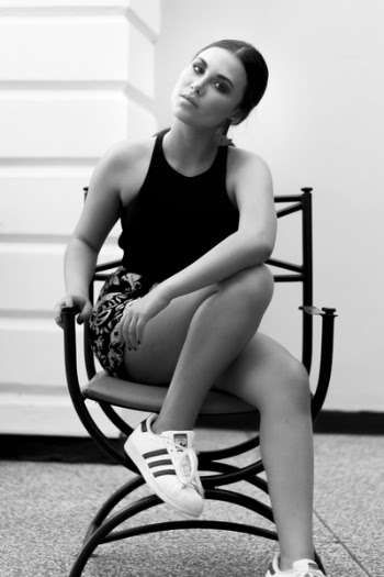 Grayscale Photo of Woman Wearing Sleeveless Tops and Floral Shorts