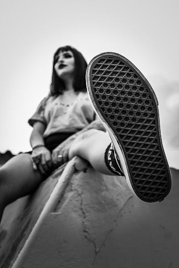 Grayscale Photo of Woman Wearing Sneakers