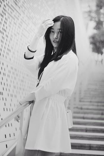 Grayscale Photo of Woman Wearing White Dress