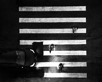 Grayscale Photo of Women Crossing Pedestrian Lane