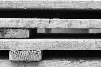 Grayscale Photo of Wooden Pallets