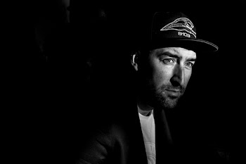 Grayscale Photo Portrait of Man in Black Cap